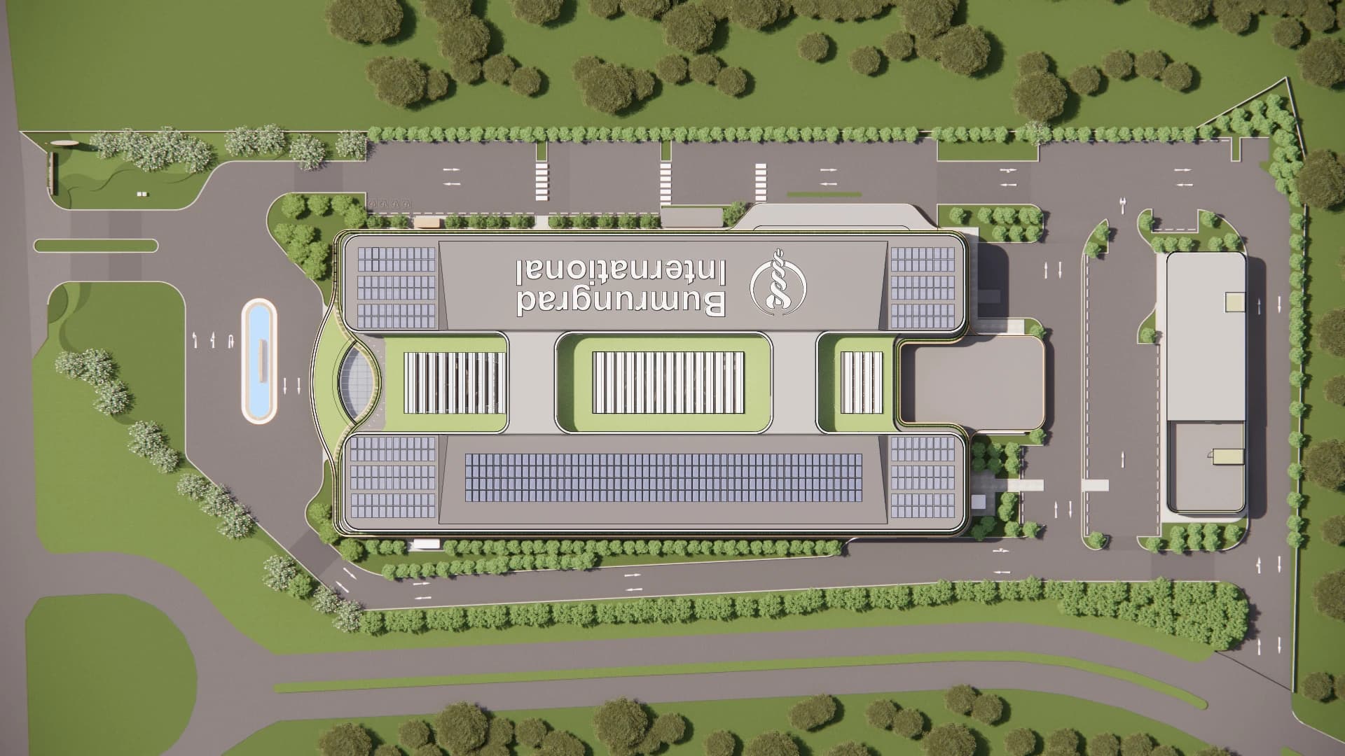 Overhead site-plan rendering showing the hospital's roof layout, internal openings, landscaped perimeter, entrance approach, and surrounding circulation.